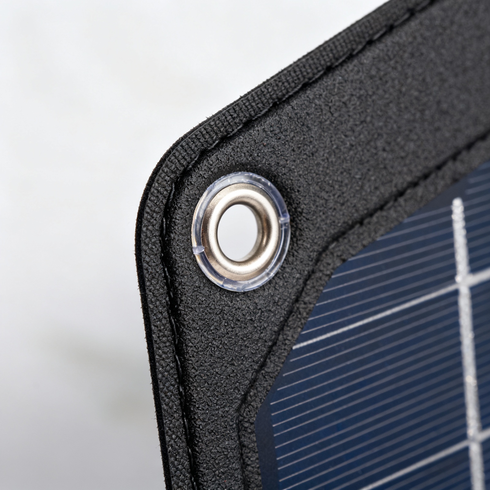 Detail of flexible solar panel mounting grommet and sealed edge construction